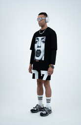 Model in the Haresquare black tshirt with a bold graphic print, styled with Haresquare Shorts in black & Luxury sunglasses – unisex luxury streetwear from Ireland.